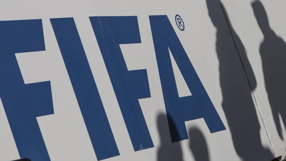 FILED - 06 January 2020, Egypt, Giza: The shadows of spectators can be seen on a FIFA banner. Photo: Omar Zoheiry/dpa