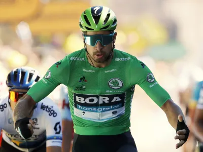 ﻿Slovakia's Peter Sagan wearing the best sprinter's green jersey celebrates as he crosses the finish line to win the fifth stage of the Tour de France cycling race over 175.5 kilometers (109 miles) with start in Saint-Die-Des-Vosges and finish in Colmar, Wednesday, July 10, 2019. (AP Photo/Christophe Ena)