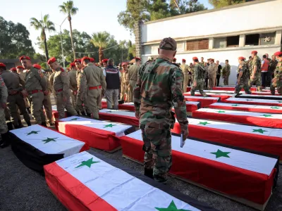 Coffins carrying the bodies of some of the people killed in an attack on a military academy, lie on the ground outside a military hospital in Homs, Syria October 6, 2023. REUTERS/Yamam al Shaar