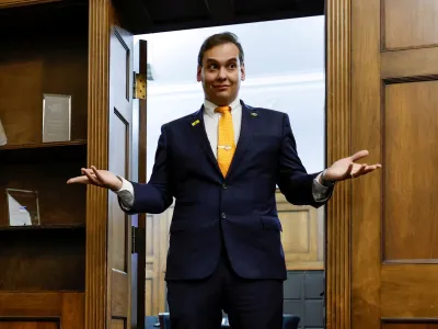 FILE PHOTO: U.S. Representative George Santos (R-NY) chats with his State of the Union guest and members of his staff as they prepare for the evening in Santos's office on Capitol Hill in Washington, U.S. February 7, 2023. REUTERS/Jonathan Ernst/File Photo