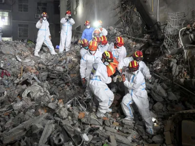 Rescue workers carry a survivor on a stretcher more than 131 hours after a building collapsed in Changsha, Hunan province, China, early May 5, 2022. cnsphoto via REUTERS  ATTENTION EDITORS - THIS IMAGE WAS PROVIDED BY A THIRD PARTY. CHINA OUT.