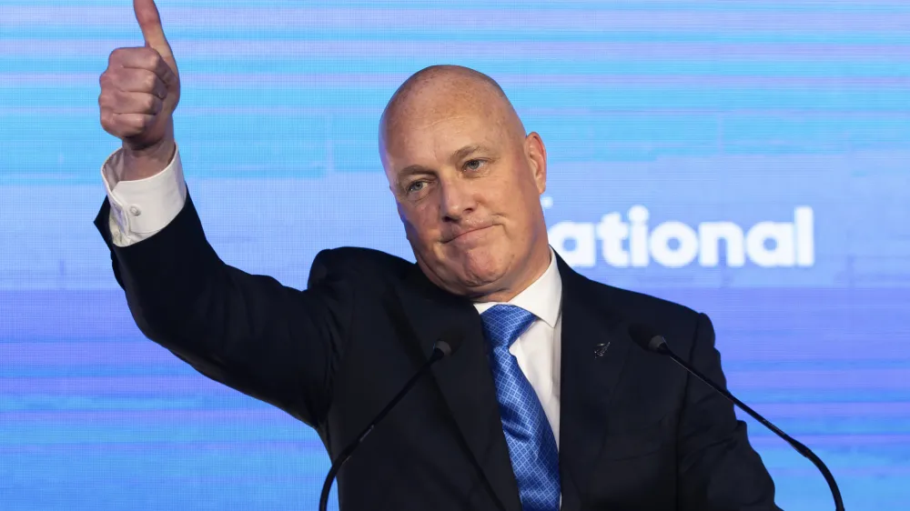 New Zealand National Party leader and Prime Minister elect Christopher Luxon gestures to supporters at a party event in Auckland, Saturday, Oct. 14, 2023, following a general election. (AP Photo/Brett Phibbs)