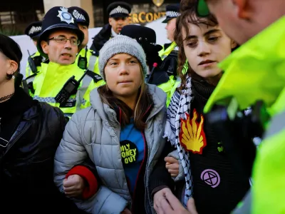 A police officer approaches Swedish climate campaigner Greta Thunberg during an Oily Money Out and Fossil Free London protest in London, Britain, October 17, 2023. REUTERS/Clodagh Kilcoyne