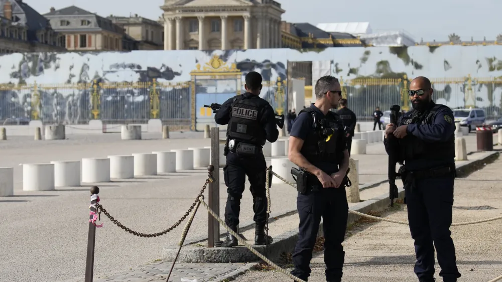 French police officers guard the entrance of the Chateau de Versailles after a security alert Tuesday, Oct. 17, 2023 in Versailles, west of Paris. The Palace of Versailles, one of France's most visited tourist attractions, is being evacuated for a security scare. It's the second time in four days the palace has had to close, with France on heightened alert against feared attacks after the fatal stabbing of a school teacher. (AP Photo/Christophe Ena)