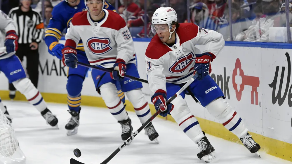 Montreal Canadiens center Jake Evans (71) skates with the puck during the second period of an NHL hockey game against the Buffalo Sabres in Buffalo, N.Y., Monday, Oct. 23, 2023. (AP Photo/Adrian Kraus)