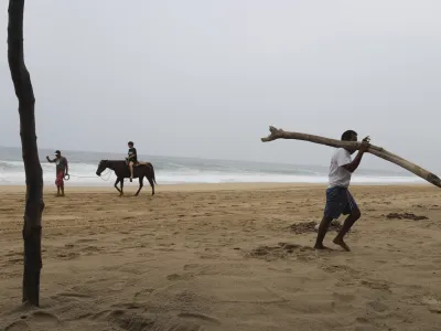 A tourist rides a horse at a beach in Acapulco, Mexico, Tuesday, Oct. 24, 2023. Hurricane Otis has strengthened from tropical storm to a major hurricane in a matter of hours as it approaches Mexico's southern Pacific coast where it was forecast to make landfall near the resort of Acapulco early Wednesday. (AP Photo/Bernardino Hernandez)