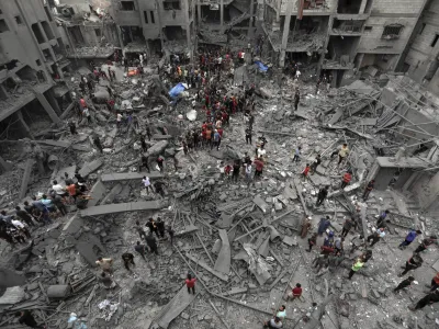 Palestinians inspect the damage of destroyed buildings following Israeli airstrikes on Gaza City, Friday, Oct. 27, 2023. (AP Photo/Abed Khaled)