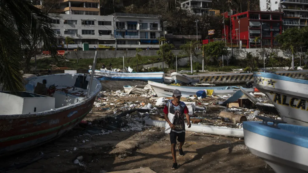 A fisherman arrives to a yacht club to join a rescue team in Acapulco, Mexico, Saturday, Oct. 28, 2023, in the aftermath of Hurricane Otis. (AP Photo/Felix Marquez)