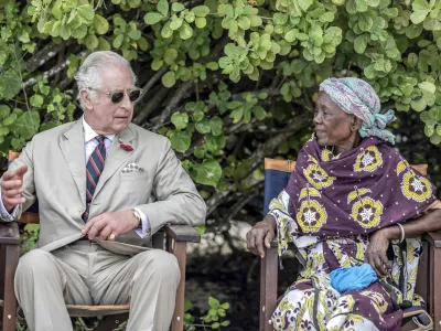 Britain's King Charles III, left, gestures as he meets with community elders during a visit to Kuruwitu Conservation Area in Kilifi, Kenya, Thursday, Nov. 2, 2023. (Luis Tato/Pool Photo via AP)