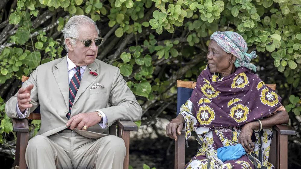 Britain's King Charles III, left, gestures as he meets with community elders during a visit to Kuruwitu Conservation Area in Kilifi, Kenya, Thursday, Nov. 2, 2023. (Luis Tato/Pool Photo via AP)