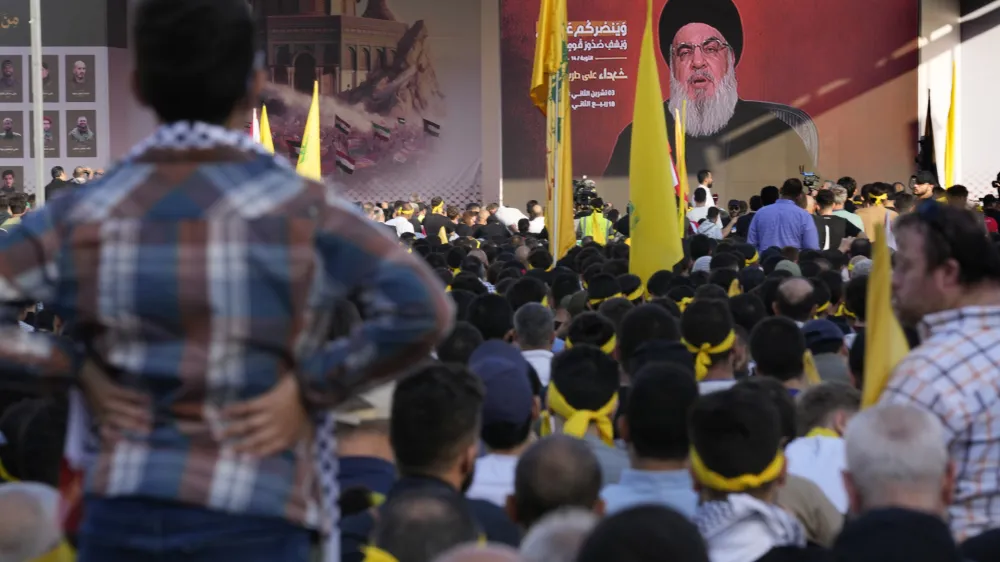 Supporters of the Iranian-backed Hezbollah group listen to Hezbollah leader Sayyed Hassan Nasrallah, who addresses a speech via a video link, during a rally to commemorate Hezbollah fighters who killed in South Lebanon last few weeks while fighting against the Israeli forces, in Beirut, Lebanon, Friday, Nov. 3, 2023. Nasrallah's speech had been widely anticipated throughout the region as a sign of whether the Israel-Hamas conflict would spiral into a regional war. (AP Photo/Hussein Malla)