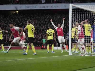 Arsenal's William Saliba, left, celebrates scoring his side's 2nd goal during the English Premier League soccer match between Arsenal and Burnley at Emirates stadium in London, England, Saturday, Nov. 11, 2023. (AP Photo/Kin Cheung)