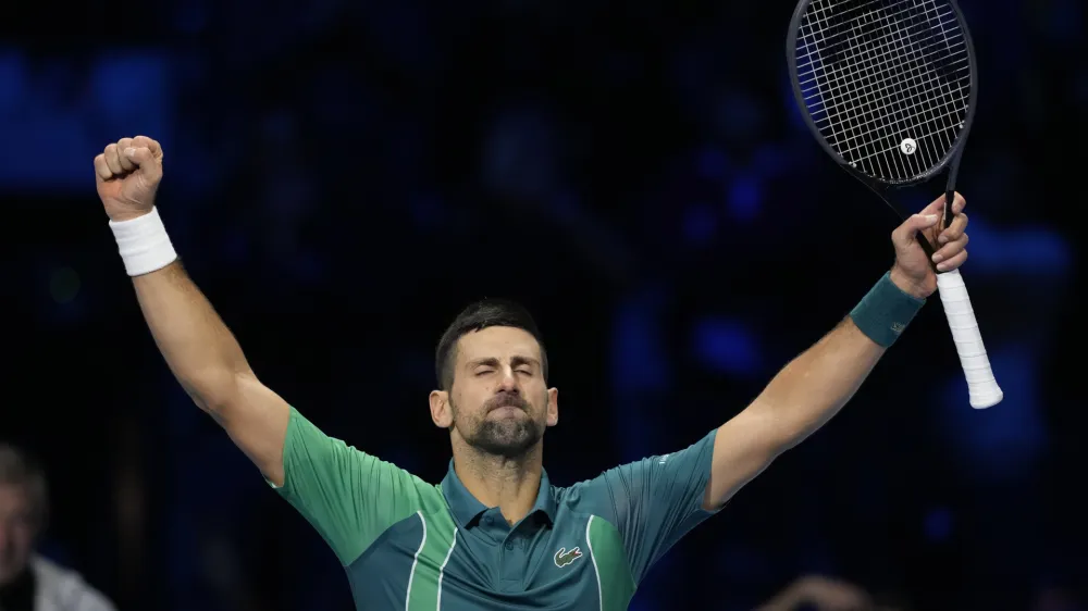 Serbia's Novak Djokovic celebrates after winning the singles tennis match against Denmark's Holger Rune, of the ATP World Tour Finals at the Pala Alpitour, in Turin, Italy, Monday, Nov. 13, 2023. (AP Photo/Antonio Calanni)