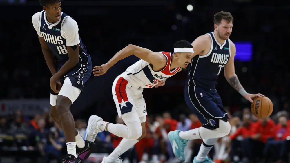 Nov 15, 2023; Washington, District of Columbia, USA; Dallas Mavericks guard Luka Doncic (77) dribbles the ball around screen by Mavericks forward Olivier-Maxence Prosper (18) as Washington Wizards guard Landry Shamet (20) defends in the second quarter at Capital One Arena. Mandatory Credit: Geoff Burke-USA TODAY Sports