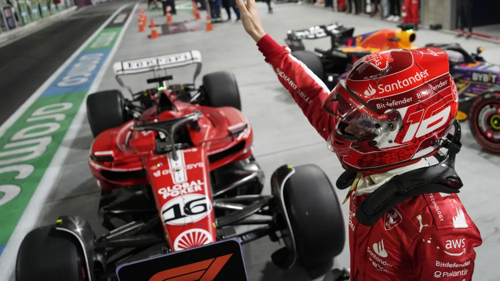 Ferrari driver Charles Leclerc, of Monaco, celebrates after winning the pole position during qualifications for the Formula One Las Vegas Grand Prix auto race, Saturday, Nov. 18, 2023, in Las Vegas. (AP Photo/John Locher)