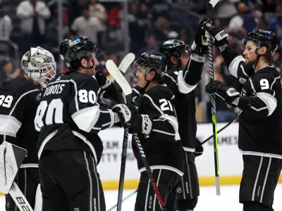 Nov 18, 2023; Los Angeles, California, USA; Los Angeles Kings center Adrian Kempe (9) high-fives with center Anze Kopitar (11) as goaltender Cam Talbot (39) and left wing Pierre-Luc Dubois (80) and defenseman Jordan Spence (21) celebrate a win after defeating the St. Louis Blues 5-1 at Crypto.com Arena. Mandatory Credit: Kiyoshi Mio-USA TODAY Sports