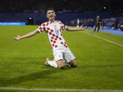 Croatia's Ante Budimir celebrates after scoring against Armenia during the Euro 2024 group D qualifying soccer match between Croatia and Armenia at the Maksimir Stadium in Zagreb, Croatia, Tuesday, Nov. 21, 2023. (AP Photo/Darko Bandic)