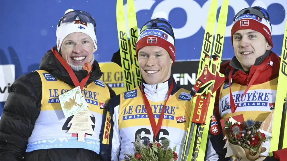 From left, second placed Iivo Niskanen of Finland, winner Martin L'wstr'm Nyenget of Norway and third placed Erik Valnes of Norway smile on the podium after the men's cross-country skiing 10 km classic style competition at the FIS World Cup Ruka Nordic Opening event in Kuusamo, Finland, Saturday, Nov. 25, 2023. (Heikki Saukkomaa/Lehtikuva via AP)