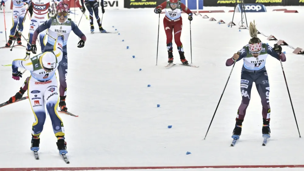 Sweden's Moa Ilar, left, crossed the finish line ahead of United State's Jessie Diggins, to win the women's 20 km mass start freestyle competition, at the cross-country ski World Cup Ruka Nordic Opening event in Kuusamo, Finland, on Sunday, Nov. 26, 2023. (Heikki Saukkomaa/Lehtikuva via AP)