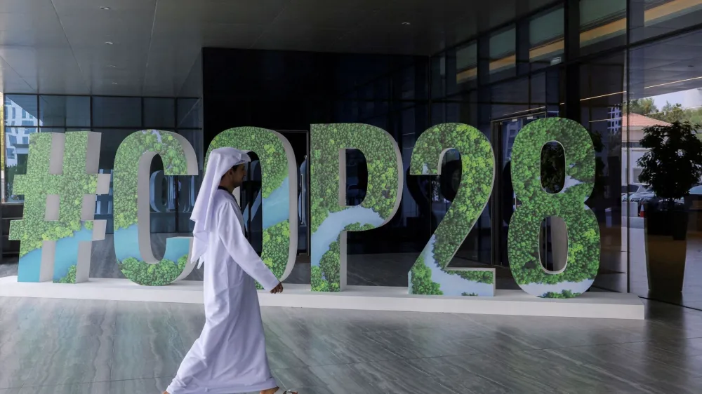 FILE PHOTO: A person walks past a "#COP28" sign in Abu Dhabi, United Arab Emirates, October 1, 2023. REUTERS/Amr Alfiky/File Photo