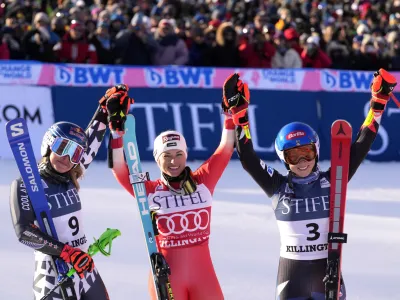 Winner Lara Gut-Behrami of Switzerland, center, celebrates with second place finisher Alice Robinson of New Zealand, left and third place Mikaela Shiffrin of United States, right, after a women's World Cup giant slalom skiing race Saturday, Nov. 25, 2023, in Killington, Vt. (AP Photo/Robert F. Bukaty)