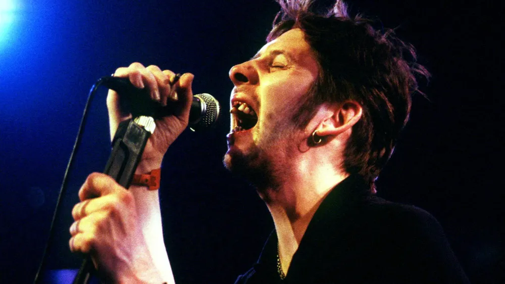 FILE PHOTO: Shane MacGowan, former lead singer of The Pogues, performs during the Montreux Jazz festival in the [Miles Davis] Hall late July 15, 1995. MacGowan and his band The Popes were part of the 'Irish Night' during the festival. REUTERS/Stringer/File Photo