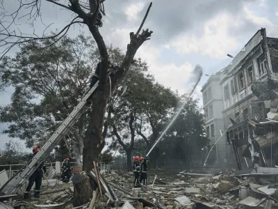 Emergency service personnel work at the site of a destroyed building after a Russian attack in Odesa, Ukraine, Thursday, July 20, 2023. Russia pounded Ukraine's southern cities, including the port city of Odesa, with drones and missiles for a third consecutive night in a wave of strikes that has destroyed some of the country's critical grain export infrastructure. (AP Photo/Libkos)