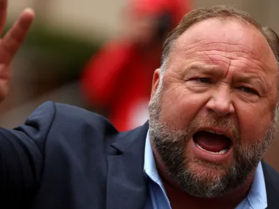 FILE PHOTO: Infowars founder Alex Jones speaks to the media after appearing at his Sandy Hook defamation trial at Connecticut Superior Court in Waterbury, Connecticut, U.S., October 4, 2022. REUTERS/Mike Segar/File Photo