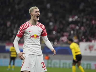 Leipzig's Benjamin Sesko celebrates after scoring his side's first goal during the group G Champions League soccer match between RB Leipzig and Young Boys Bern at the Red Bull arena stadium in Leipzig, Germany, Wednesday, Dec. 13, 2023. (AP Photo/Matthias Schrader)