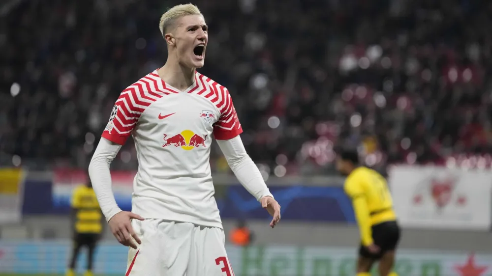 Leipzig's Benjamin Sesko celebrates after scoring his side's first goal during the group G Champions League soccer match between RB Leipzig and Young Boys Bern at the Red Bull arena stadium in Leipzig, Germany, Wednesday, Dec. 13, 2023. (AP Photo/Matthias Schrader)