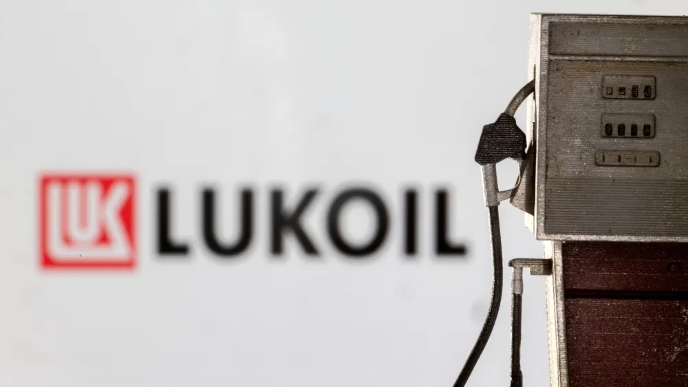 Model of petrol pump is seen in front of LUKOIL logo in this illustration taken March 25, 2022. REUTERS/Dado Ruvic/Illustration