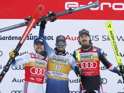 From left, second placed Norway's Aleksander Aamodt Kilde, the winner Italy's Dominik Paris and third placed United States' Bryce Bennett celebrate after an alpine ski, men's World Cup downhill race, in Val Gardena, Italy, Saturday, Dec. 16, 2023. (AP Photo/Alessandro Trovati)