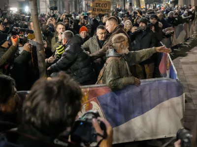 Serbian opposition supporters shout slogans during a protest joined by several thousand people, outside the country's electoral commission in Belgrade, Serbia, Monday, Dec. 18, 2023. An early official vote count of Serbia's weekend election on Monday confirmed victory for the ruling populist party in a parliamentary vote in the Balkan country, but political tensions rose over reported irregularities in the capital, Belgrade. (AP Photo/Darko Vojinovic)