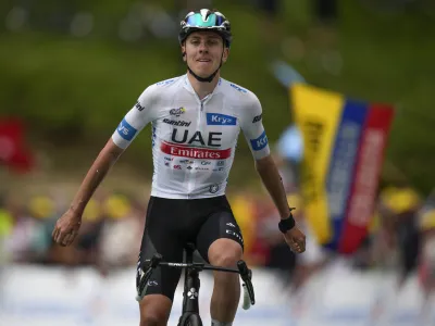 Slovenia's Tadej Pogacar celebrates as he crosses the finish line to win the sixth stage of the Tour de France cycling race over 145 kilometers (90 miles) with start in Tarbes and finish in Cauterets-Cambasque, France, Thursday, July 6, 2023. (AP Photo/Daniel Cole)