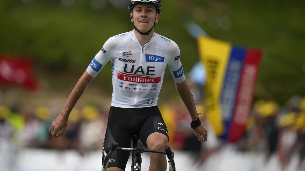 Slovenia's Tadej Pogacar celebrates as he crosses the finish line to win the sixth stage of the Tour de France cycling race over 145 kilometers (90 miles) with start in Tarbes and finish in Cauterets-Cambasque, France, Thursday, July 6, 2023. (AP Photo/Daniel Cole)