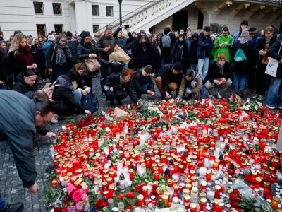 People lay tributes at a memorial during a vigil following a shooting at one of Charles University's buildings in Prague, Czech Republic, December 22, 2023. REUTERS/David W Cerny