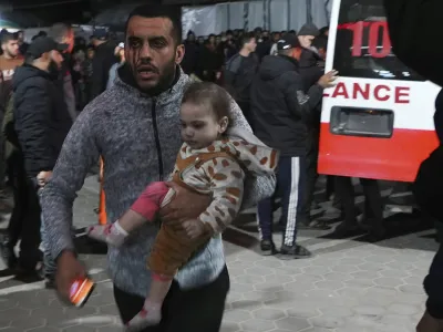 Palestinians wounded in the Israeli bombardment of the Gaza Strip arrive at the hospital in Deir al Balah, Gaza Strip, on Saturday, Dec. 23, 2023. (AP Photo/Adel Hana)