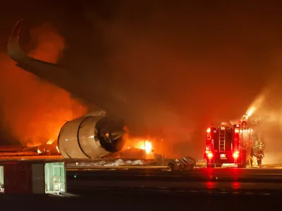 Firefighters work at Haneda International Airport after Japan Airlines' A350 airplane caught on fire, in Tokyo, Japan January 2, 2024. REUTERS/Issei Kato