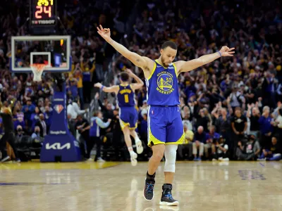 Golden State Warriors' Stephen Curry (30) celebrates a 3-pointer by Klay Thompson's against the Memphis Grizzles during the second half in Game 6 of the Western Conference semifinals of the NBA basketball playoffs in San Francisco on Friday, May 13, 2022. The Warriors defeated the Grizzlies 110-96 to advance to the conference finals. (Carlos Avila Gonzalez/San Francisco Chronicle via AP)