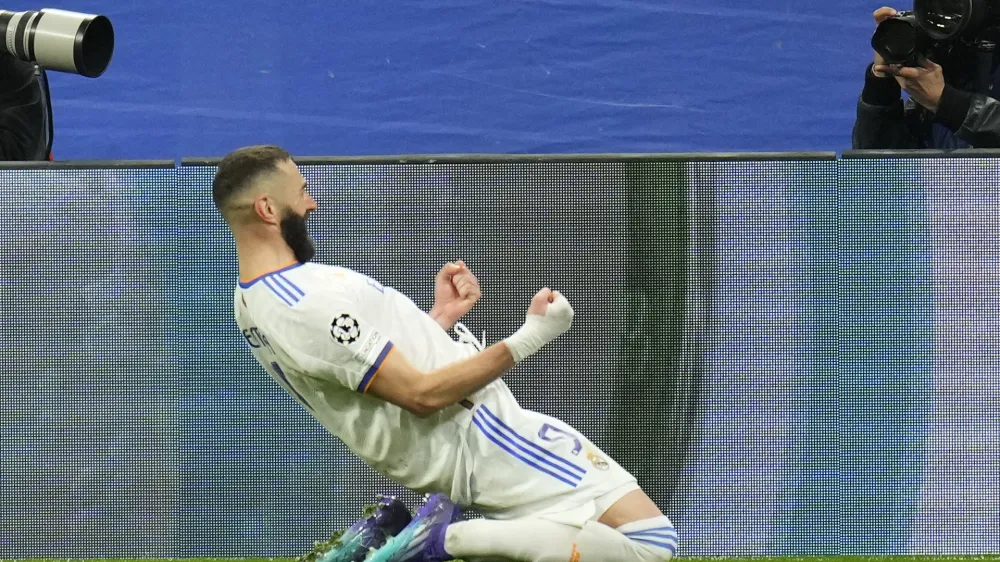 Real Madrid's Karim Benzema celebrates scoring his side's third goal during the Champions League, round of 16, second leg soccer match between Real Madrid and Paris Saint-Germain at the Santiago Bernabeu stadium in Madrid, Spain, Wednesday, March 9, 2022. (AP Photo/Manu Fernandez)