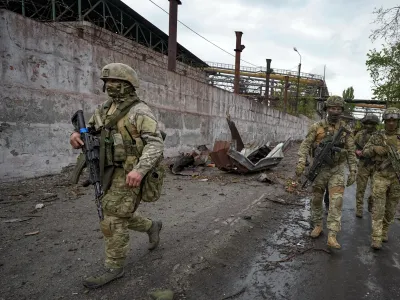 Russian soldiers patrol a destroyed part of the Illich Iron & Steel Works Metallurgical Plant in Mariupol, in territory under the government of the Donetsk People's Republic, eastern Ukraine, Wednesday, May 18, 2022. This photo was taken during a trip organized by the Russian Ministry of Defense. (AP Photo)