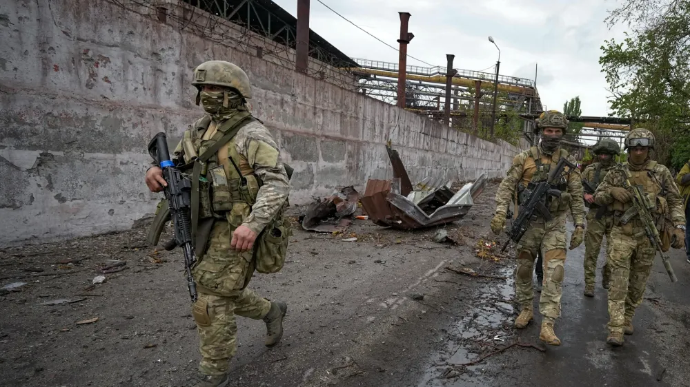 Russian soldiers patrol a destroyed part of the Illich Iron & Steel Works Metallurgical Plant in Mariupol, in territory under the government of the Donetsk People's Republic, eastern Ukraine, Wednesday, May 18, 2022. This photo was taken during a trip organized by the Russian Ministry of Defense. (AP Photo)