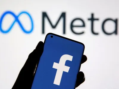 FILE PHOTO: A smartphone with Facebook's logo is seen in front of displayed Facebook's new rebrand logo Meta in this illustration taken October 28, 2021. REUTERS/Dado Ruvic/Illustration//File Photo