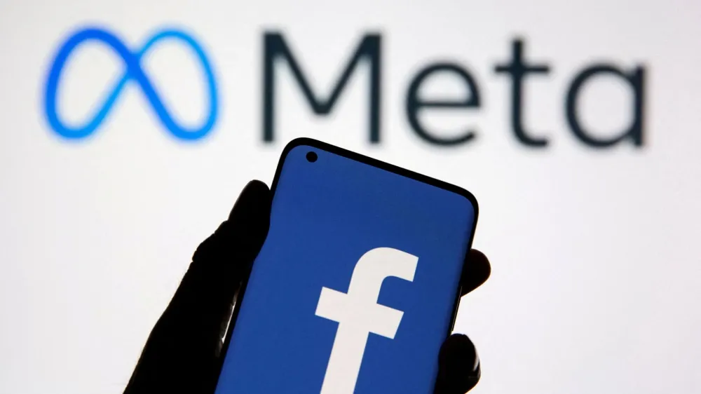 FILE PHOTO: A smartphone with Facebook's logo is seen in front of displayed Facebook's new rebrand logo Meta in this illustration taken October 28, 2021. REUTERS/Dado Ruvic/Illustration//File Photo