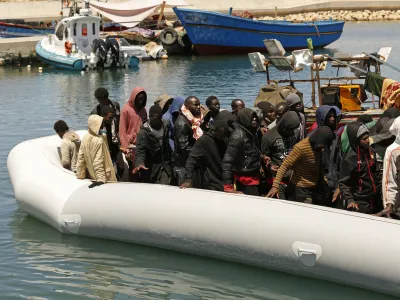 Migrants heading to Europe are brought back to port after being intercepted in the Mediterranean Sea by the Libyan coast guard, in Gasr Garabulli, northwestern Libya, Monday, May 23 2022. (AP Photo/Yousef Murad)