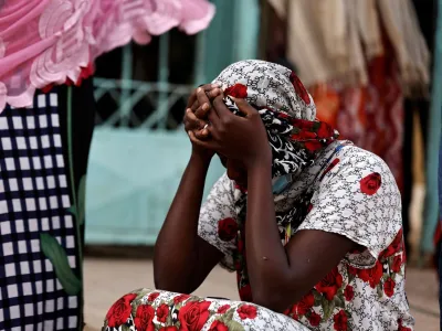 Kaba, a mother of a ten-day-old baby, reacts as she sits outside the hospital, where newborn babies died in a fire at the neonatal section of a regional hospital in Tivaouane, Senegal, May 26, 2022. REUTERS/Zohra Bensemra