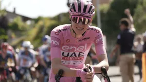 Slovenia's Tadej Pogacar, wearing the pink jersey of the race overall leader, smiles prior to starting the 15th stage of the Giro d'Italia from Manerba del Garda to Livigno, Italy, Sunday, May 19, 2024. (Massimo Paolone/LaPresse via AP)