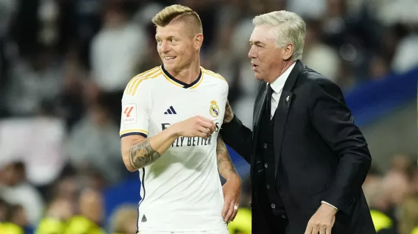 FILE - Real Madrid's head coach Carlo Ancelotti, right, and Real Madrid's Toni Kroos talk during the Spanish La Liga soccer match between Real Madrid and Deportivo Alaves at the Santiago Bernabeu stadium in Madrid, Spain, on May 14, 2024. Real Madrid said the 34-year-old German international "has decided to bring an end to his time as a professional footballer following Euro 2024." (AP Photo/Jose Breton, File)