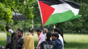 20 May 2024, Hesse, Frankfurt/Main: Participants set up a pro-Palestinian protest camp on the campus of Goethe University hold a banner reading "Palestine is moving forward - show us how it can be done!". Photo: Boris Roessler/dpa