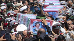 In this photo released by the Iranian Presidency Office, flag-draped coffins of the President Ebrahim Raisi and his companions who were killed in a helicopter crash on Sunday, are carried during their funeral ceremony in the city of Mashhad, Iran, Thursday, May 23, 2024. Iran on Thursday prepared to inter its late president at the holiest site for Shiite Muslims in the Islamic Republic, a final sign of respect for a protégé of Iran's supreme leader killed in a helicopter crash earlier this week. (Iranian Presidency Office via AP)